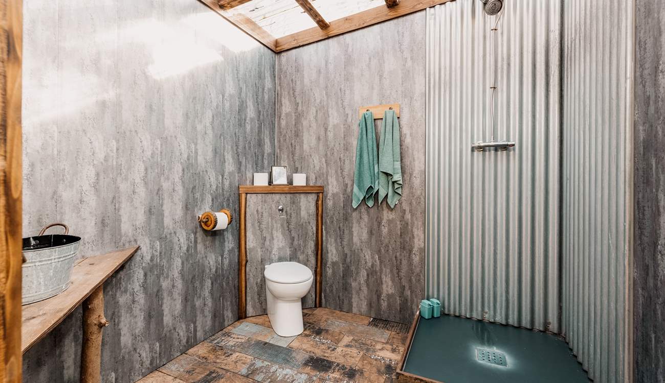 With a transparent roof which makes it feel as though you are showering in the wilderness. 