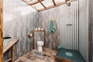 With a transparent roof which makes it feel as though you are showering in the wilderness.