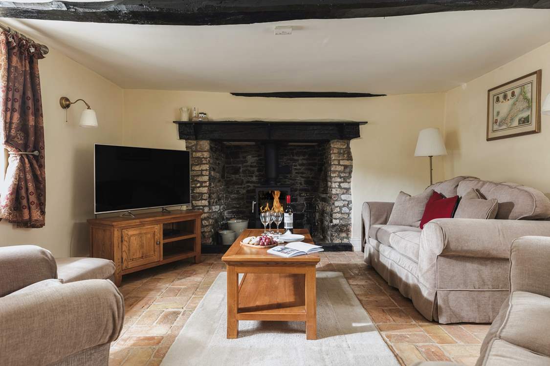 Welcome to Cobble Cottage. The cosy sitting-room, complete with warming wood-burner, offers the perfect retreat at the end of the day.