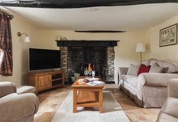 Welcome to Cobble Cottage. The cosy sitting-room, complete with warming wood-burner, offers the perfect retreat at the end of the day.