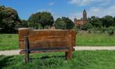 Sit and contemplate from the wooden bench Quarr Abbey in the distance. - Thumbnail Image