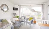 The living space is light and bright with patio doors to the front.  - Thumbnail Image