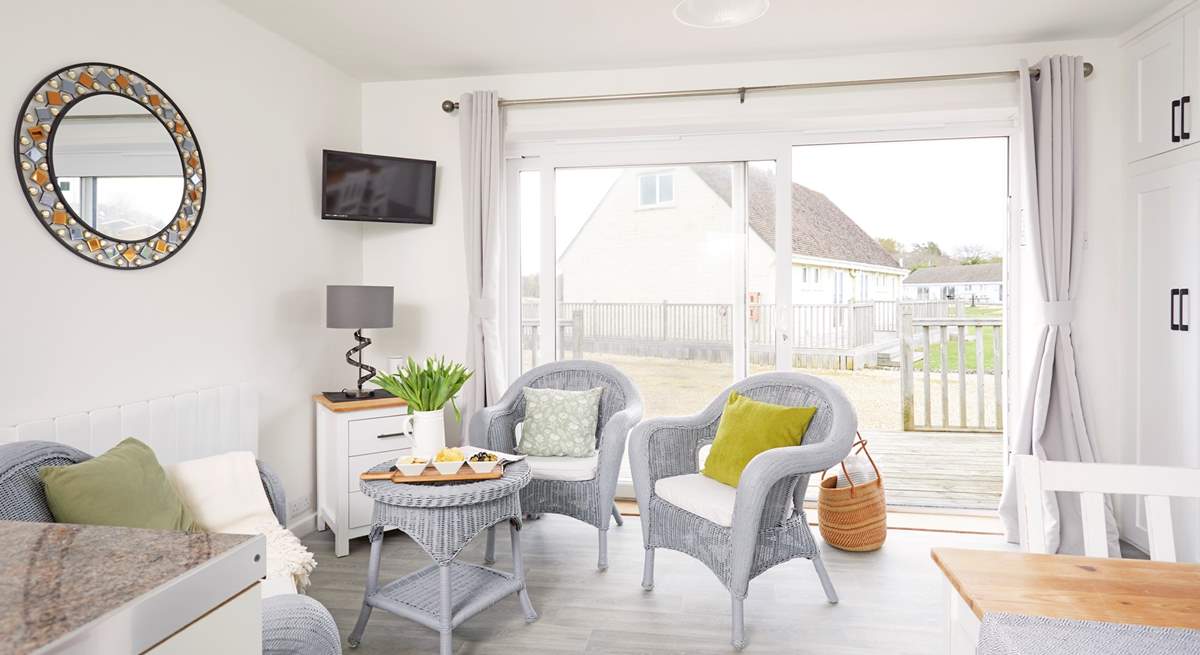 The living space is light and bright with patio doors to the front. 