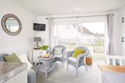 The living space is light and bright with patio doors to the front. 