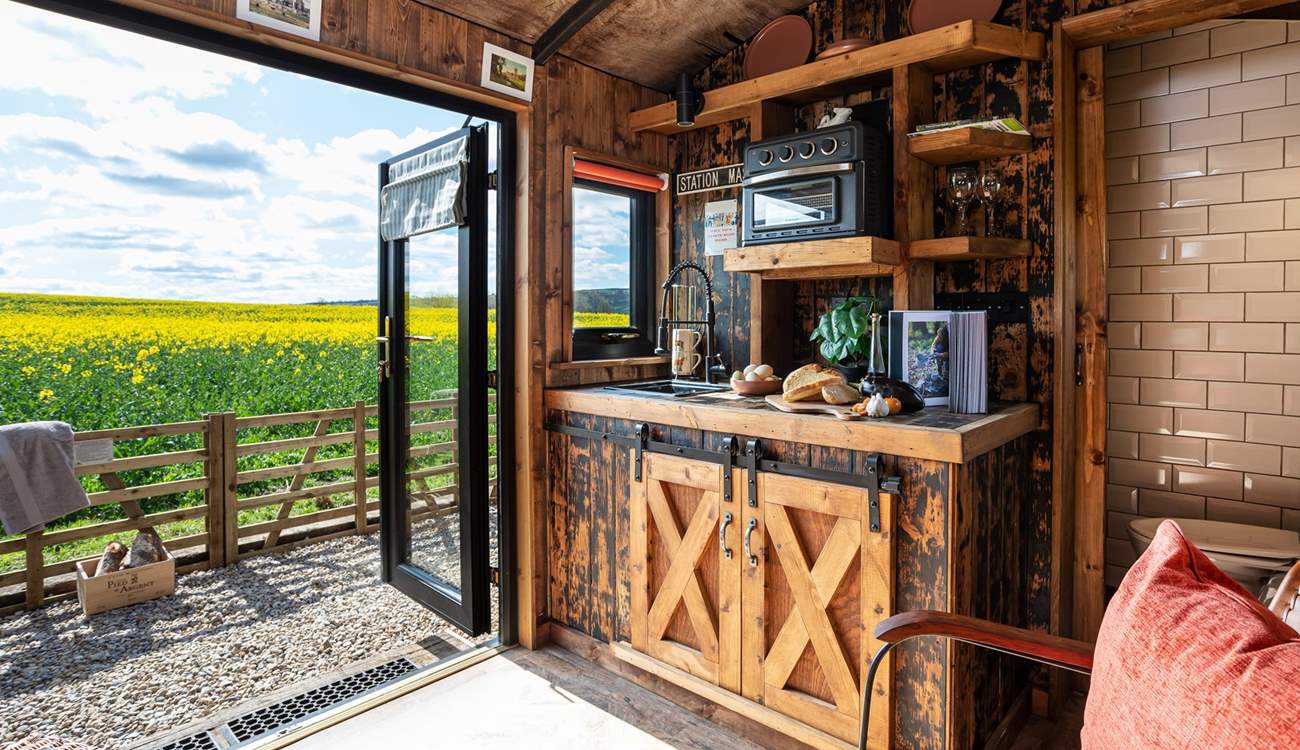 The quirky kitchen is well-equipped for your glamping getaway. Please note: The mini oven has been changed to an air fryer. 