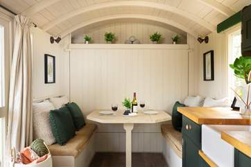 The queen-size (4') bed cleverly folds away, revealing a lovely dining area during the day.