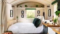 Emerald green tones create a calming atmosphere for your glamping getaway.