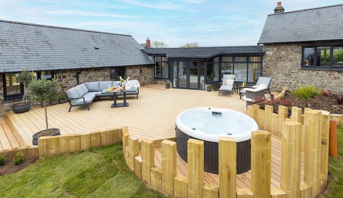 Soak in the hot tub as the sun slowly sets.