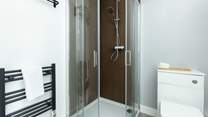 Each bedroom enjoys a modern en suite with a shower and heated towel rail.
