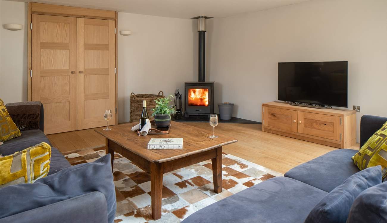 The cosy living area is fully equipped with wood-burner.