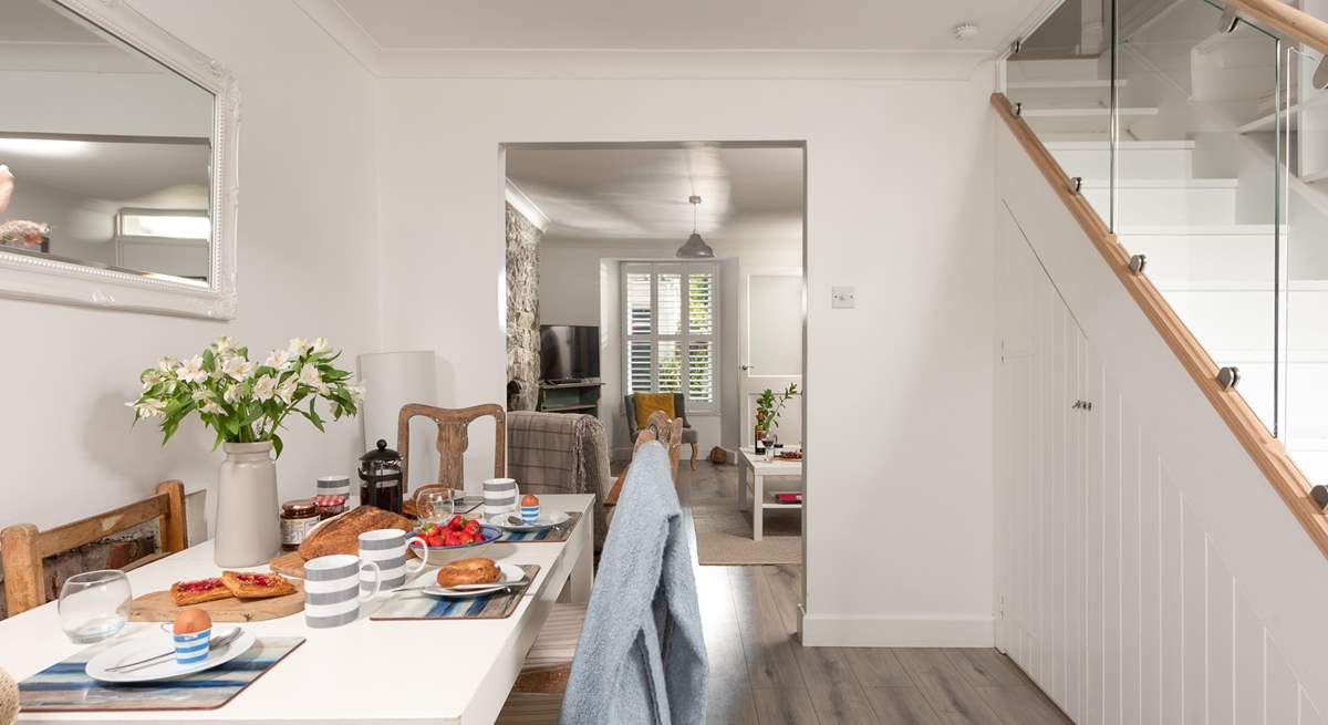 The dining-table is perfectly situated in between the sitting-room and the kitchen.