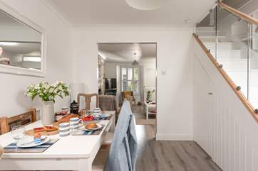 The dining-table is perfectly situated in between the sitting-room and the kitchen.