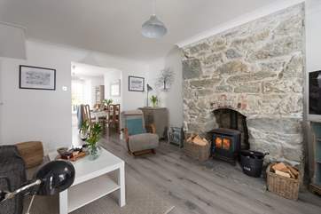 The lovely sitting/dining-room is cosy and welcoming.