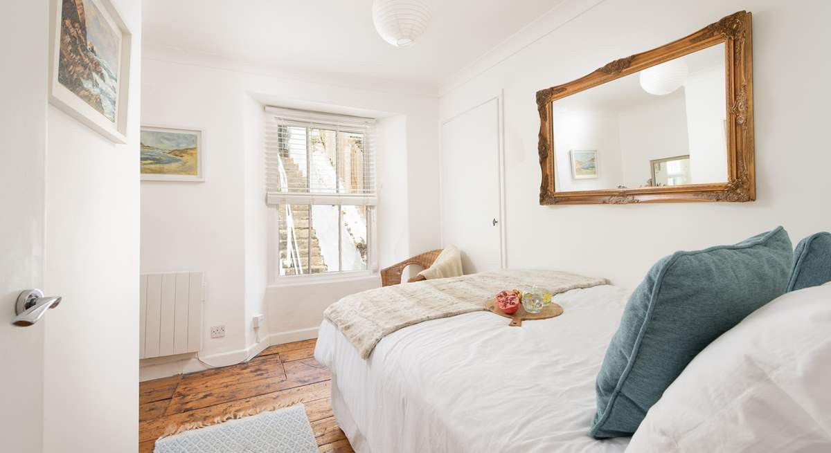 Bedroom 2 looks out into the rear courtyard and steps to the deck area. 