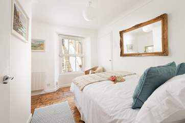 Bedroom 2 looks out into the rear courtyard and steps to the deck area.