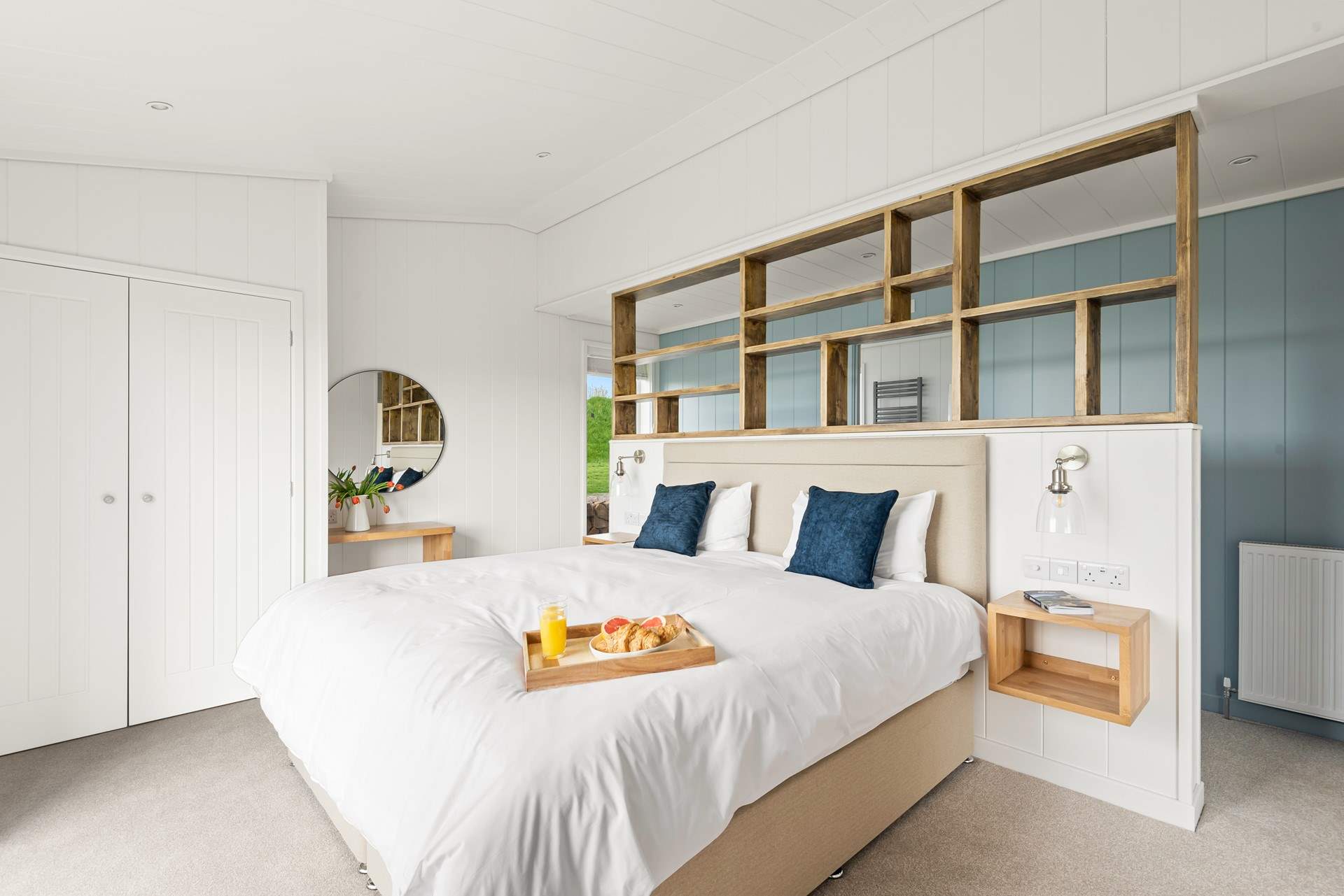 The fabulous bedroom with stylish en suite bathroom through the door behind the bed.