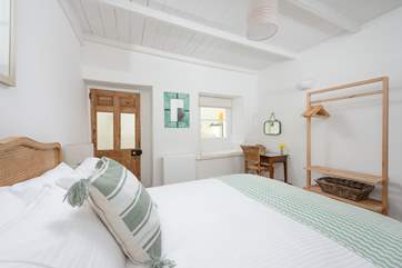 Bedroom 1 on the ground floor has a comfy king-size bed. This room is suitable for a cot.