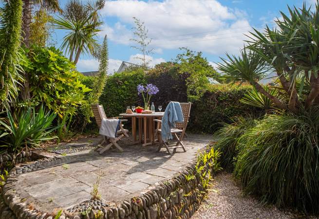 The secluded back garden is surrounded by fabulous sub-tropical plants. 
Take great care of the varying levels, steps and quirky patio with slightly uneven slabs. 