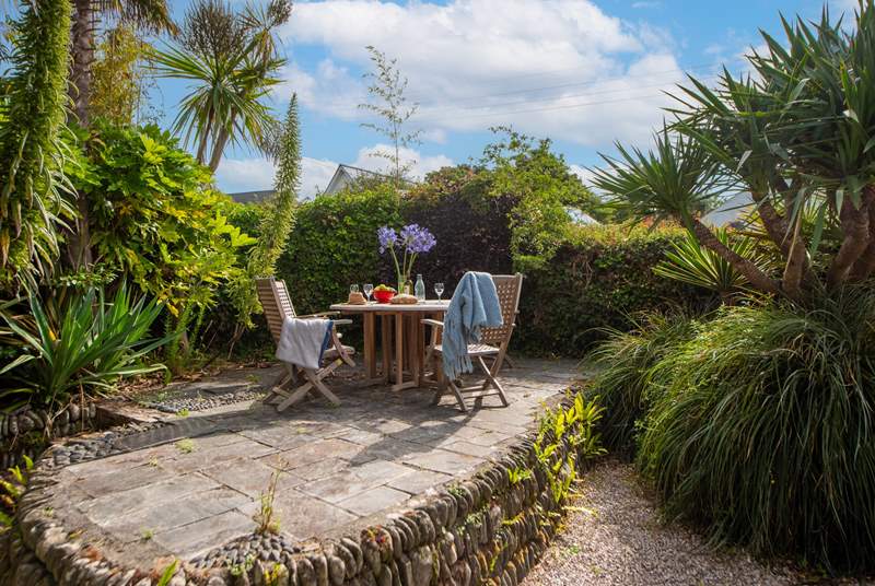 The secluded back garden is surrounded by fabulous sub-tropical plants. 
Take great care of the varying levels, steps and quirky patio with slightly uneven slabs. 