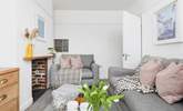 The cosy sitting-room is furnished in relaxing pastel shades. - Thumbnail Image