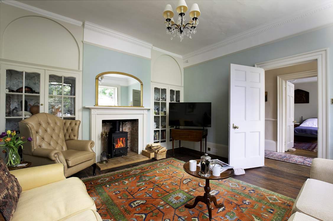 The sitting-room has plenty of seating, and a delightful wood-burning stove for those chilly days. The door leads to the twin bedroom.