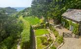 Views across the garden out to the coast (please note, the building on the right is secured and used for storage purposes only during the 2023 season however it is anticipated that it will be in use as a dwelling in 2024).  - Thumbnail Image