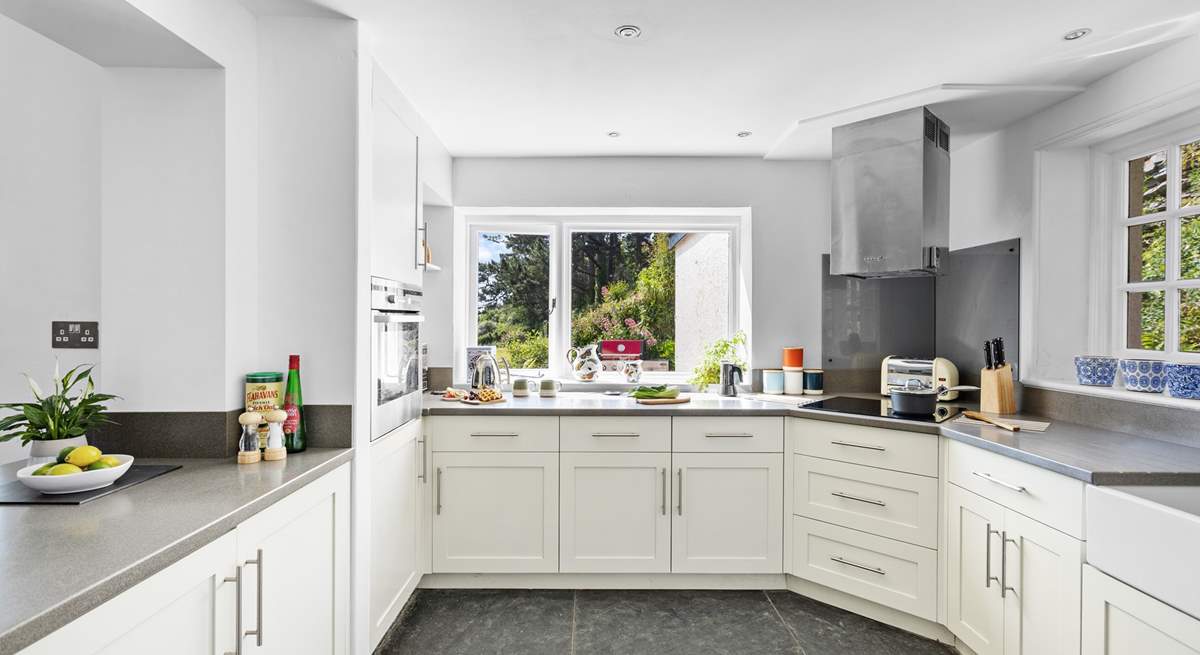 At the end of the open plan living/dining space the fully equipped kitchen can be found with views out to the coast across the garden.