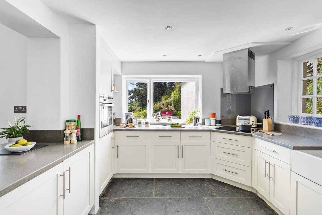 At the end of the open plan living/dining space the fully equipped kitchen can be found with views out to the coast across the garden.