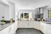 At the end of the open plan living/dining space the fully equipped kitchen can be found with views out to the coast across the garden.