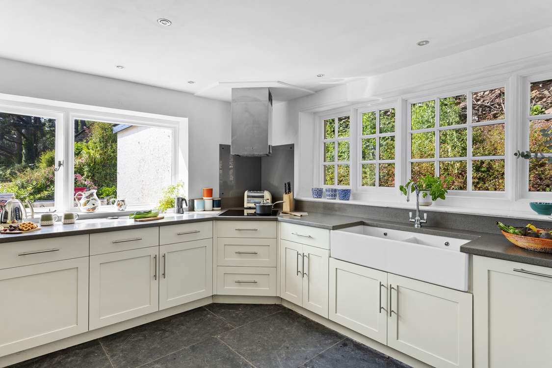 A kitchen that floods with light and is fully-equipped. The fridge/freezer is found in the utility-room.