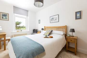 The pretty main bedroom has a comfy king-size bed for a restful night.
