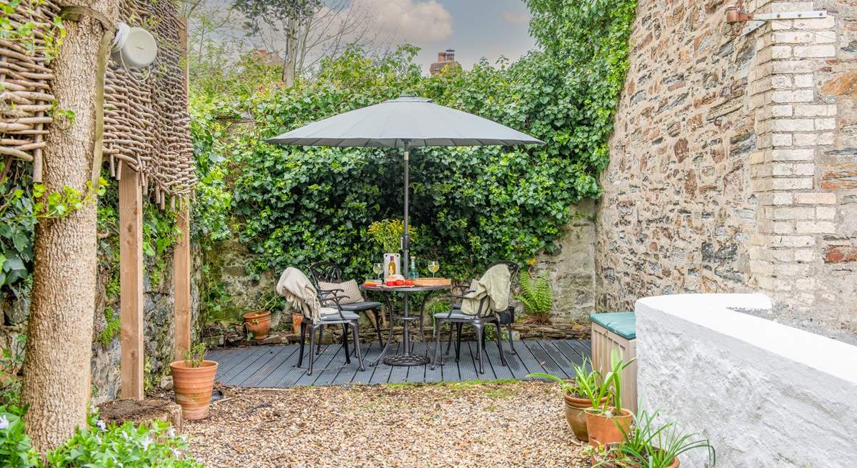 The idyllic top patio is a fantastic spot for evening drinks. Please supervise children as behind the white wall is the flat roof of the utility-room. 