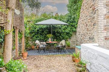 The idyllic top patio is a fantastic spot for evening drinks. Please supervise children as behind the white wall is the flat roof of the utility-room.