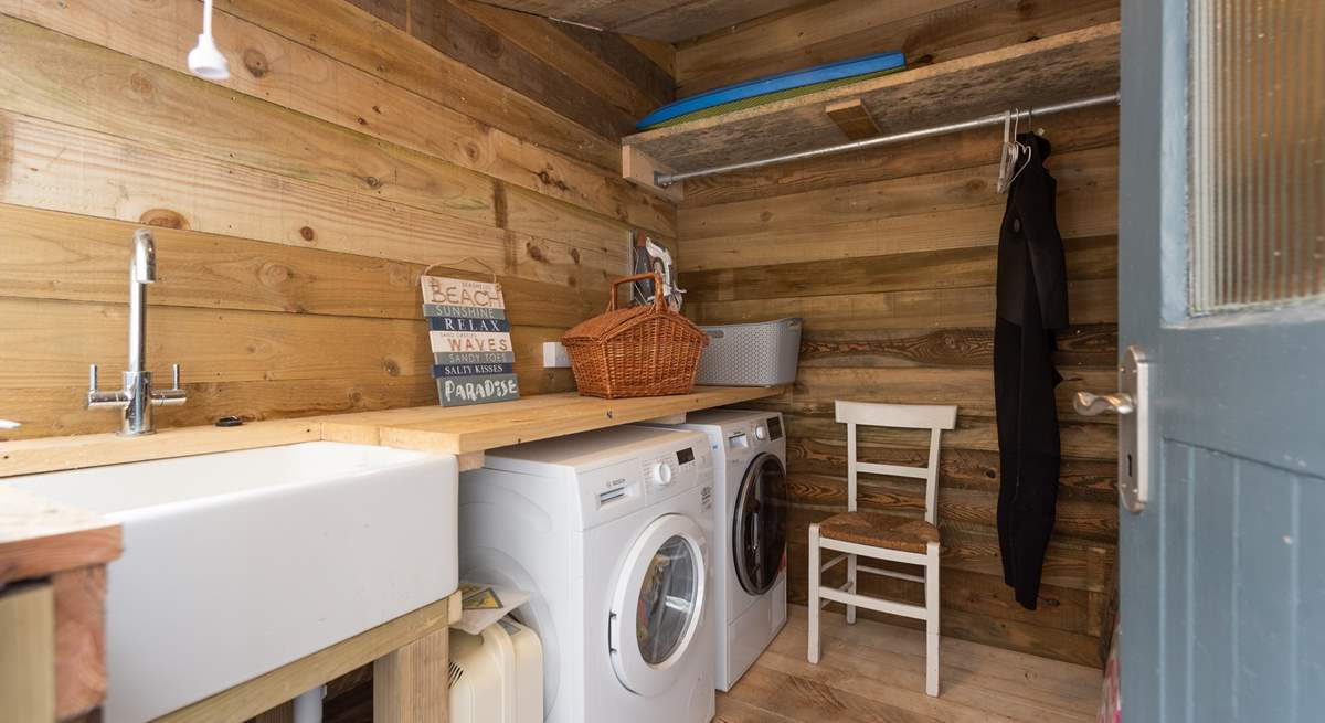 The utility-room has a washing machine and tumble-drier.