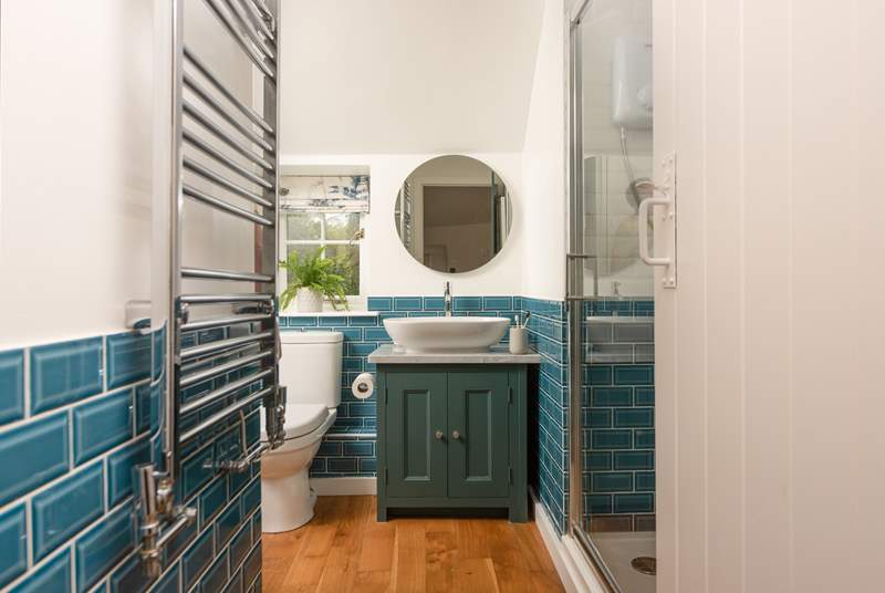 The stylish family bathroom has a bath and separate shower cubicle.