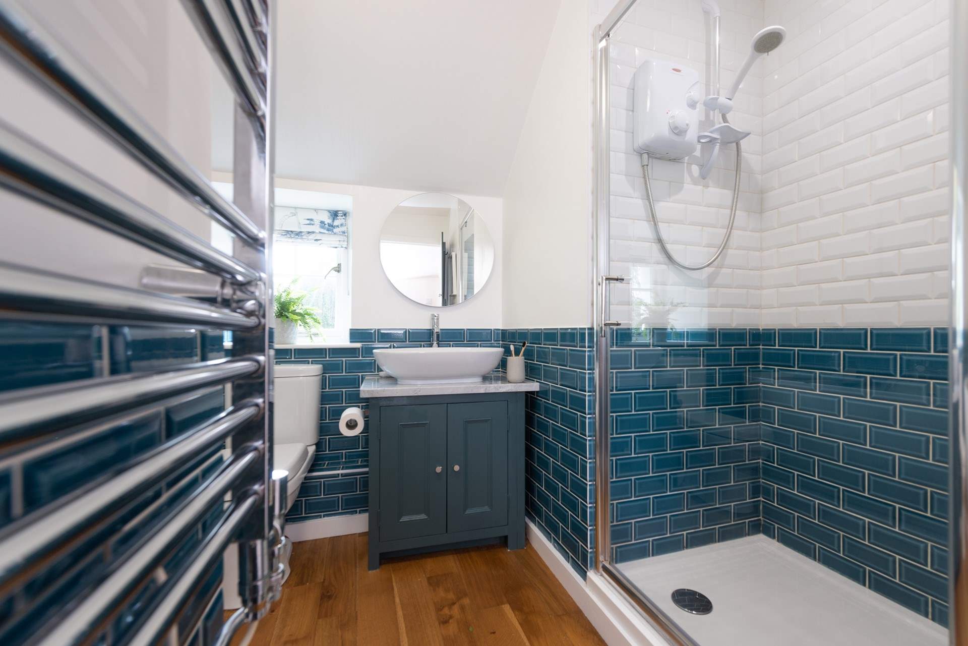 The lovely family bathroom has a large shower and separate bath.