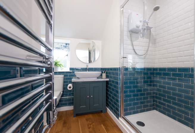 The lovely family bathroom has a large shower and separate bath.