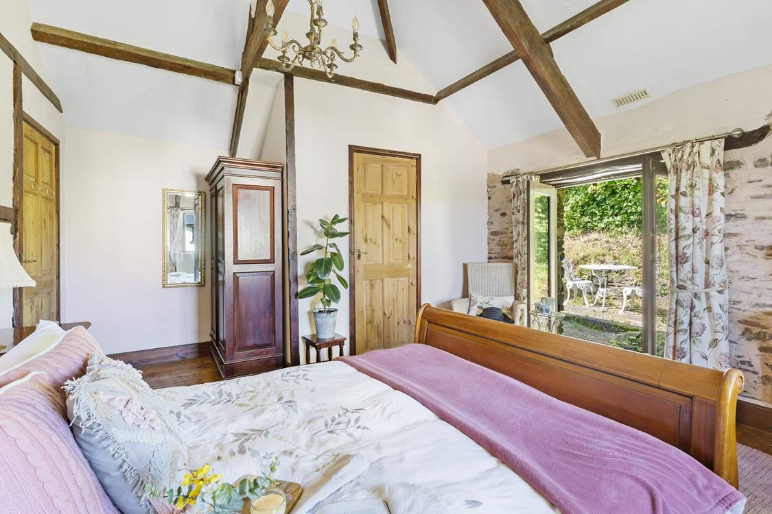 Bedroom 1 with a gorgeous king-size bed and en suite Shower-room enjoys access to the private patio area that leads up to your secret garden. Each room has a lovely vaulted ceiling!