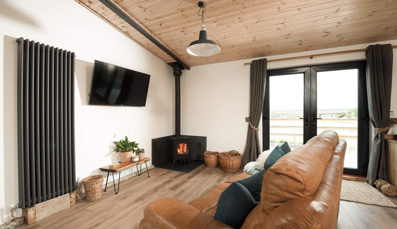 Snuggle up in the sitting area and feel the warmth from the wood-burner. 