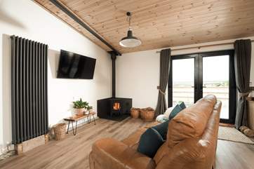 Snuggle up in the sitting area and feel the warmth from the wood-burner.