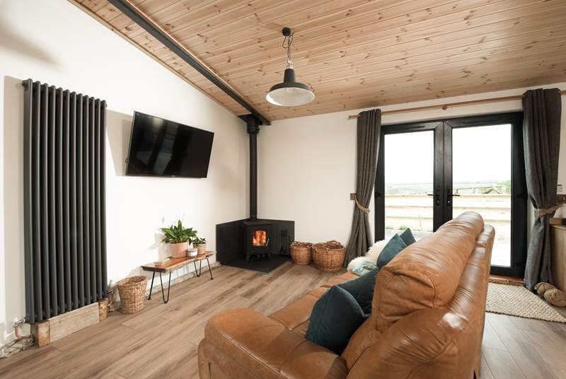 Snuggle up in the sitting area and feel the warmth from the wood-burner. 