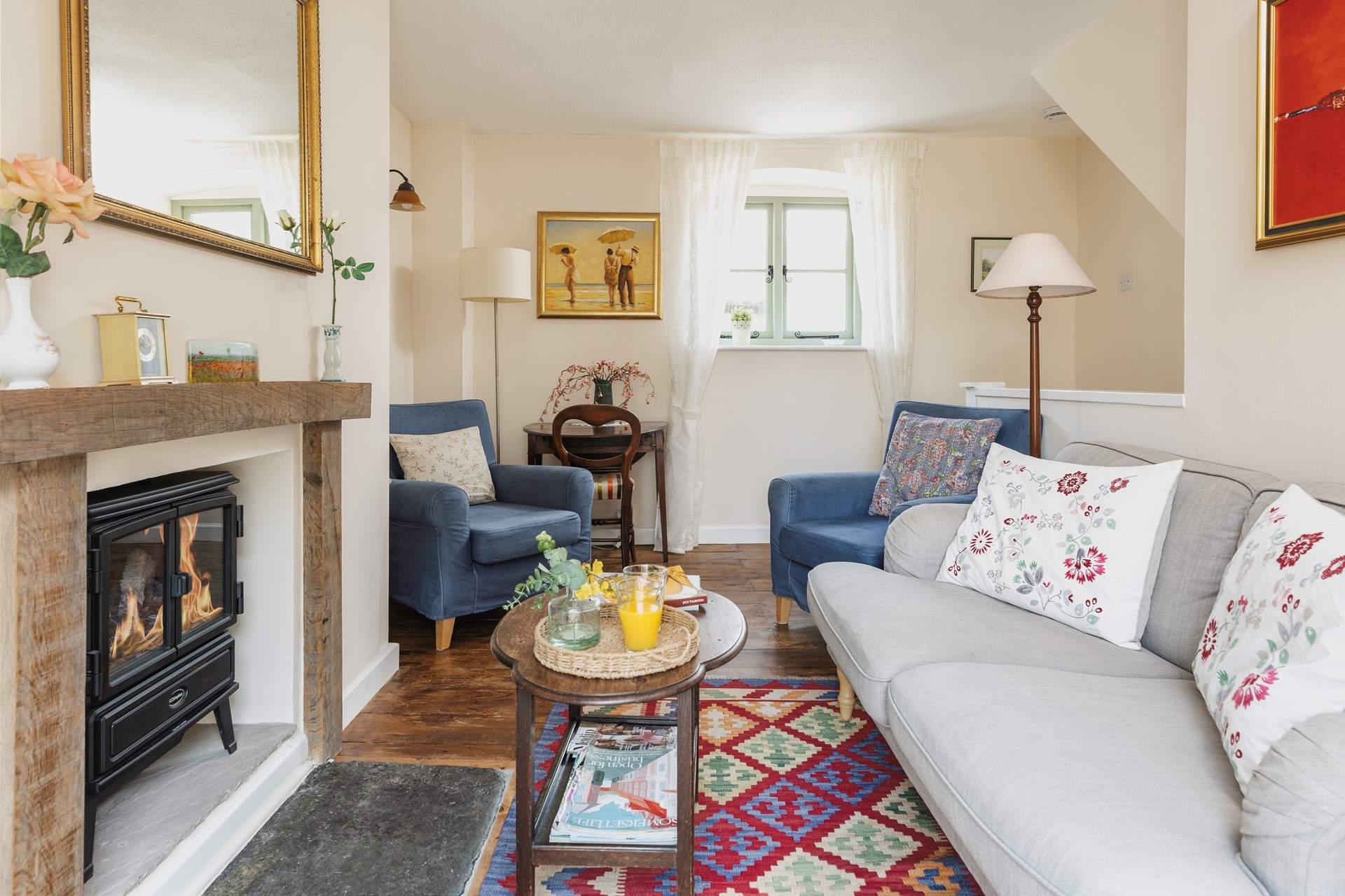 The sitting-room is comfy and cute.