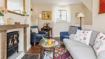 The sitting-room is comfy and cute.