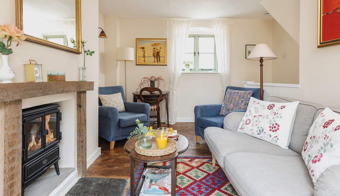 The sitting-room is comfy and cute.