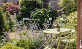 There is a shared, dainty spot outside for some al fresco dining. - Thumbnail Image