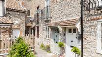 With its welcoming green door, the cottage can be found in a quiet setting close to the centre of Wells.