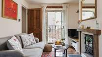 The Juliet balcony adds light to the pretty sitting-room and provides a welcome breeze though the room on warmer days.