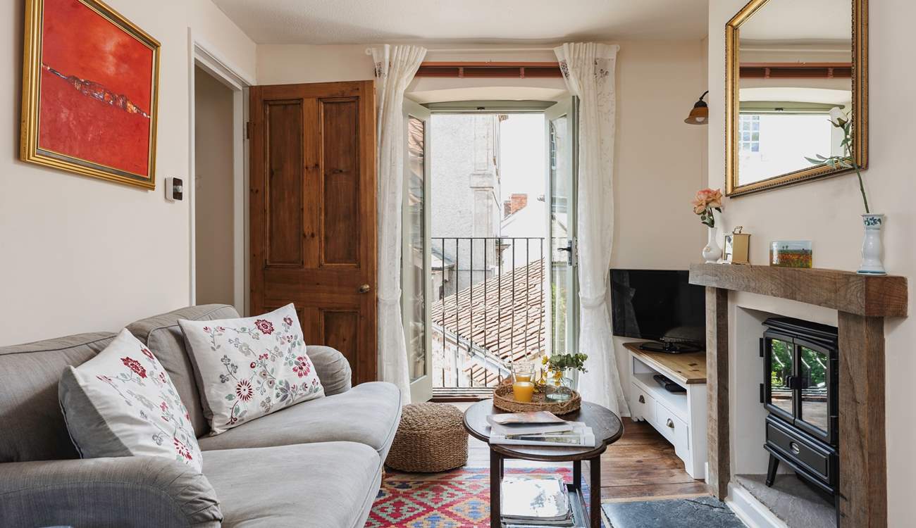 The Juliet balcony adds light to the pretty sitting-room and provides a welcome breeze though the room on warmer days.