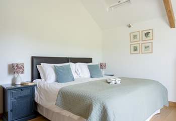 The main bedroom is serene and tastefully decorated.