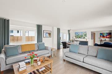 The open plan living space is beautifully furnished in pastel shades.